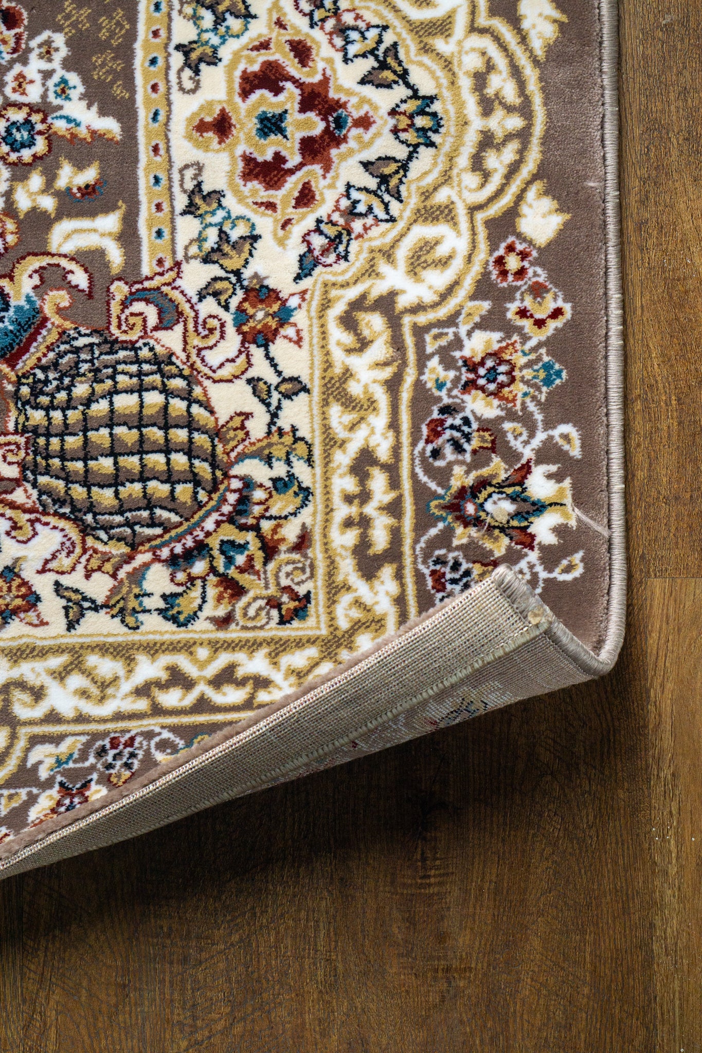 Brown traditional Persian rug with cream medallion and ornate floral borders