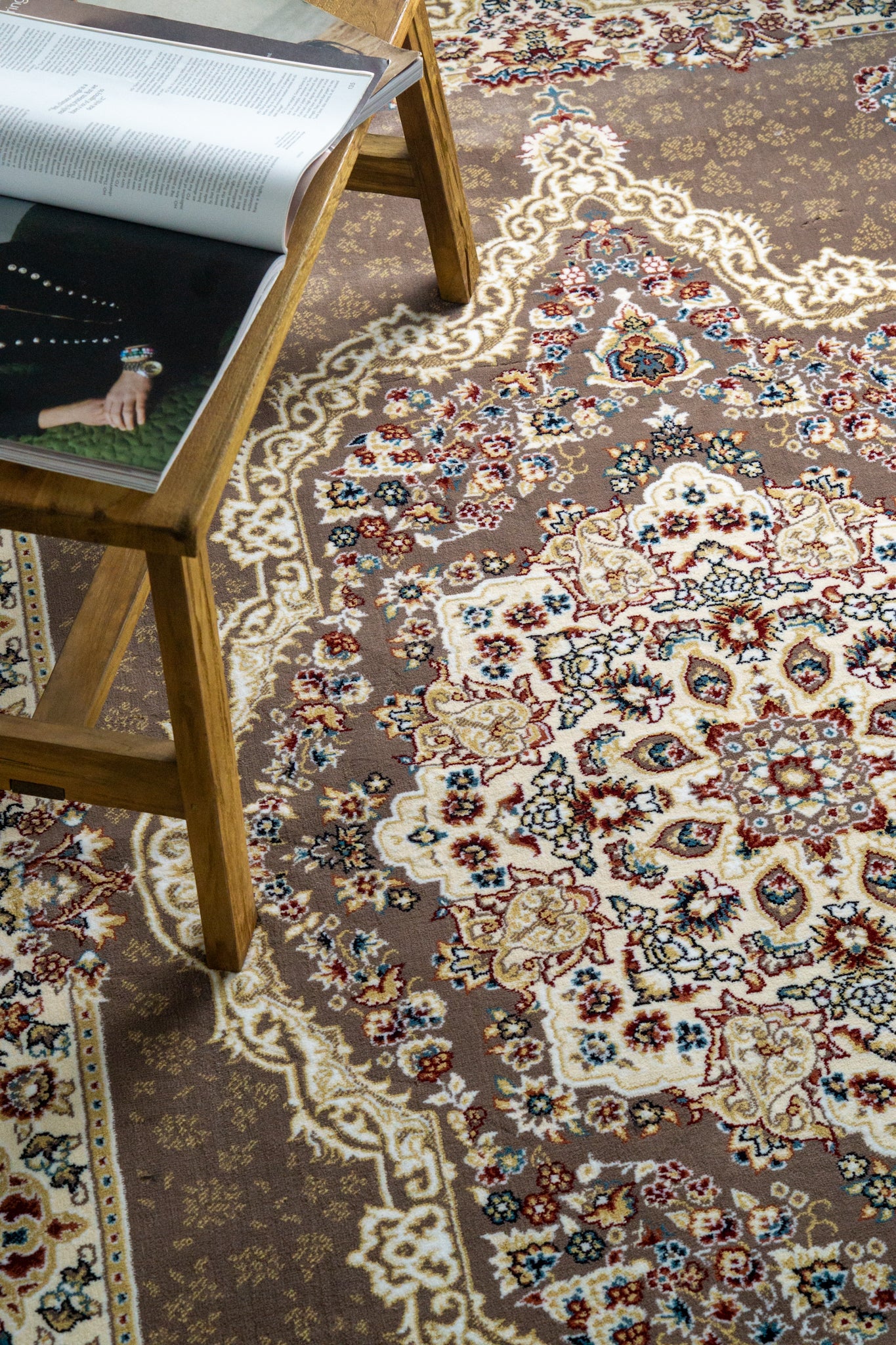 Brown traditional Persian rug with cream medallion and ornate floral borders