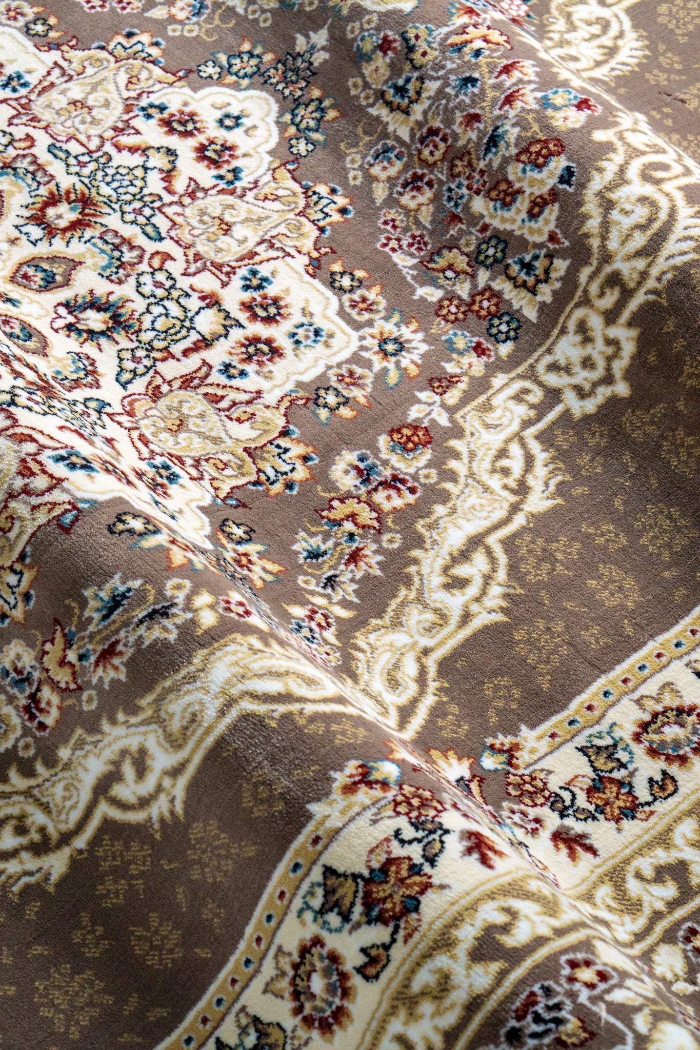 Brown traditional Persian rug with cream medallion and ornate floral borders