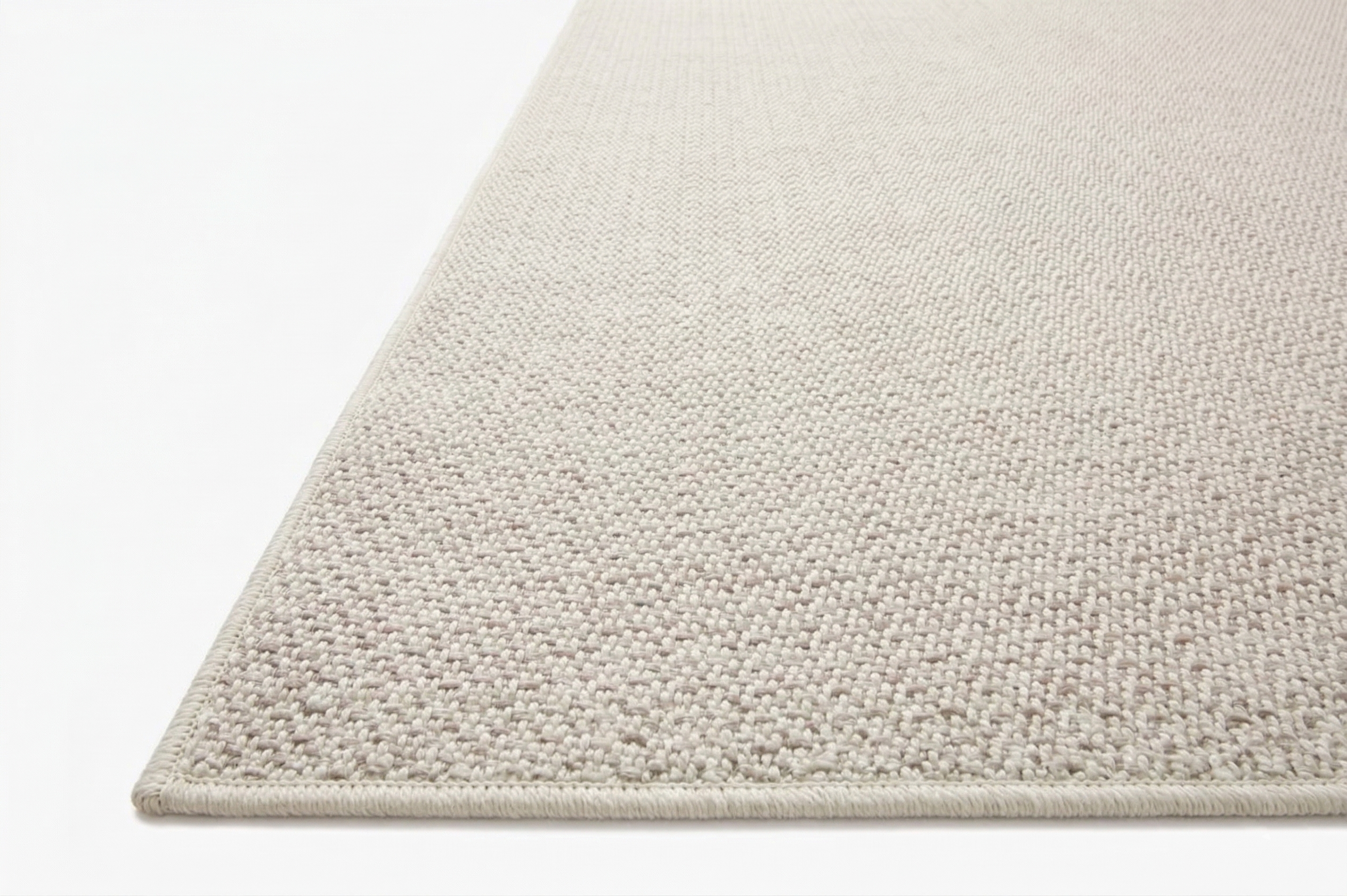 Neutral beige herringbone textured rug with subtle woven pattern throughout