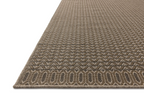 Tan and brown geometric patterned rug with textured weave and striped borders