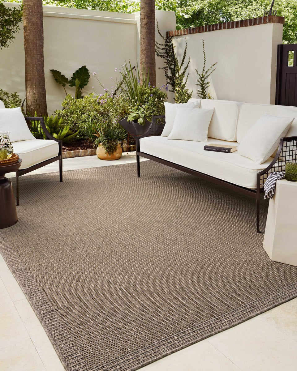 Neutral beige textured woven rug with fine ribbed pattern throughout