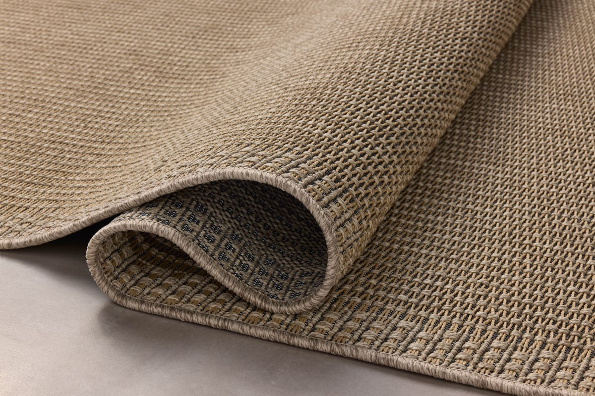 Neutral beige textured woven rug with fine ribbed pattern throughout