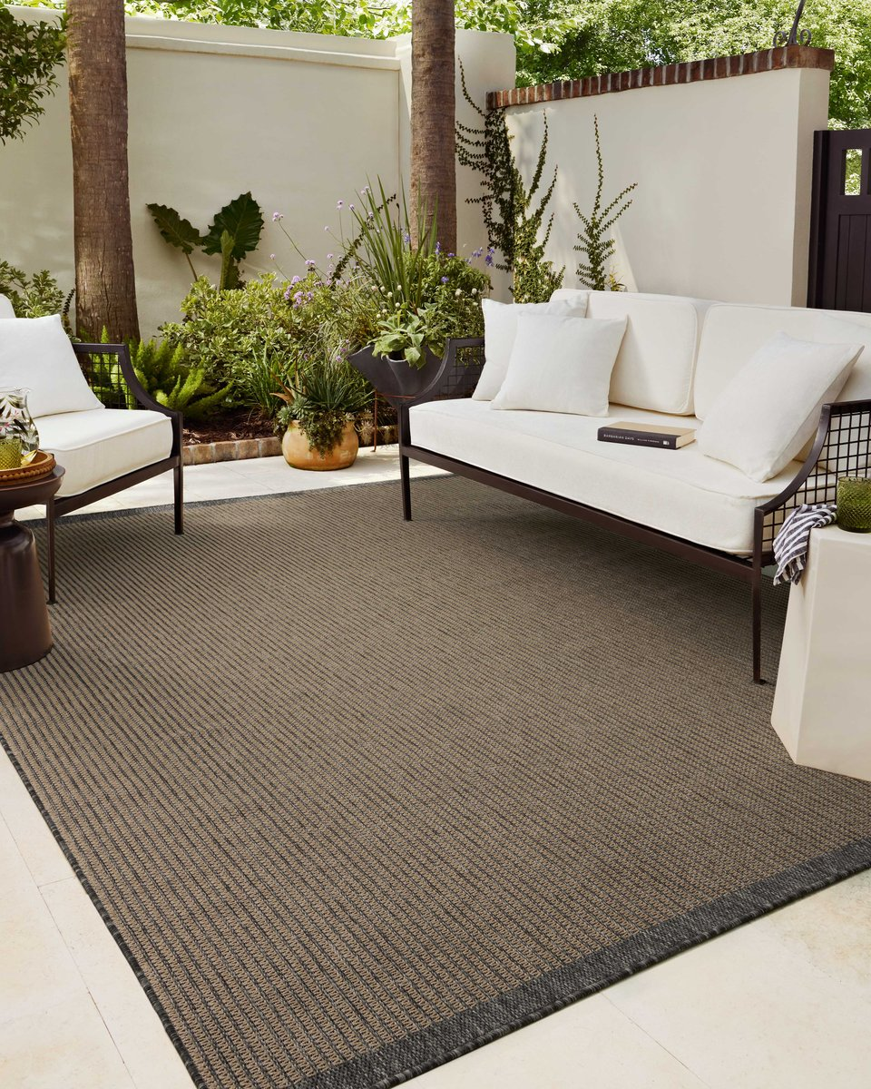Neutral striped rug with subtle texture and dark border detail