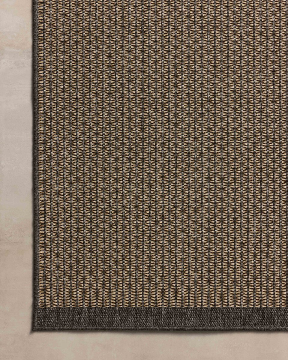 Neutral striped rug with subtle texture and dark border detail