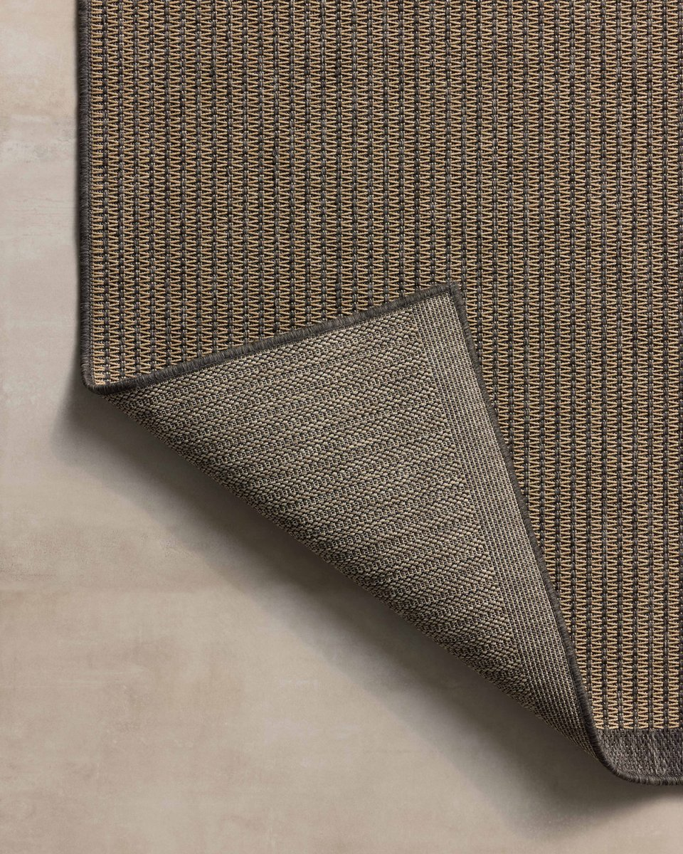 Neutral striped rug with subtle texture and dark border detail