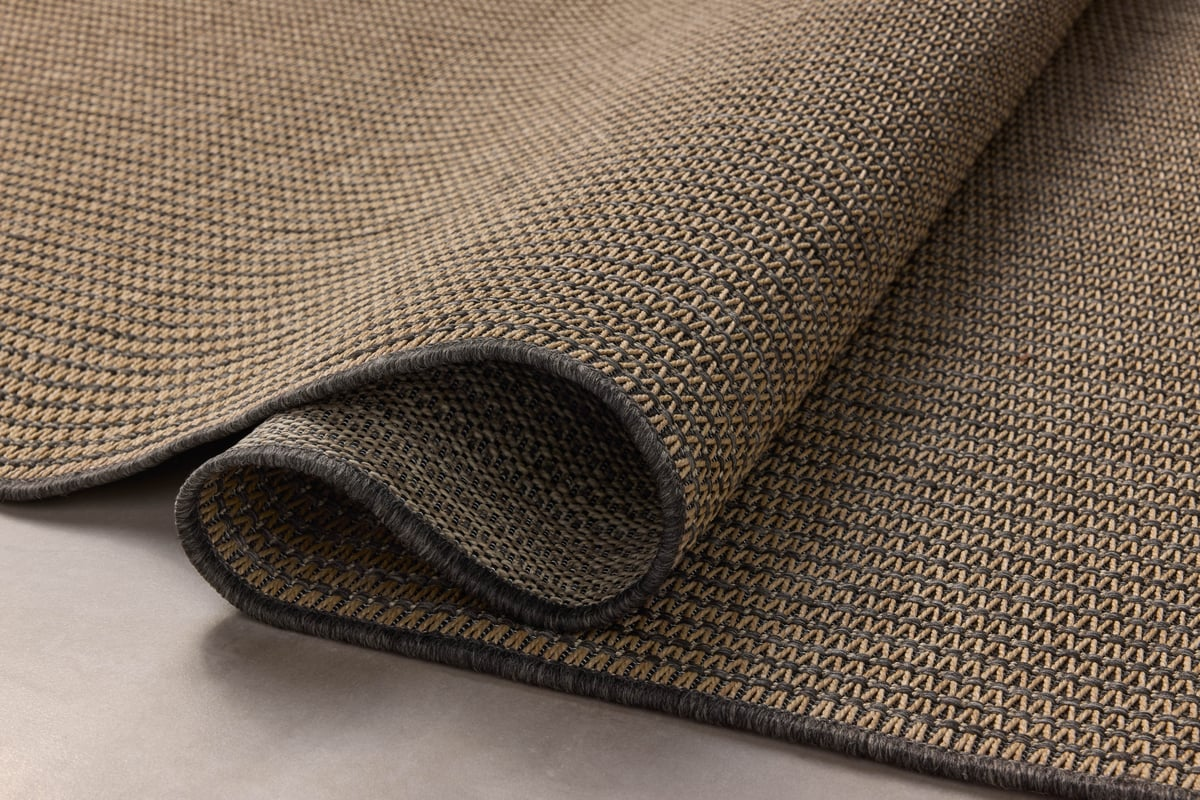 Neutral striped rug with subtle texture and dark border detail