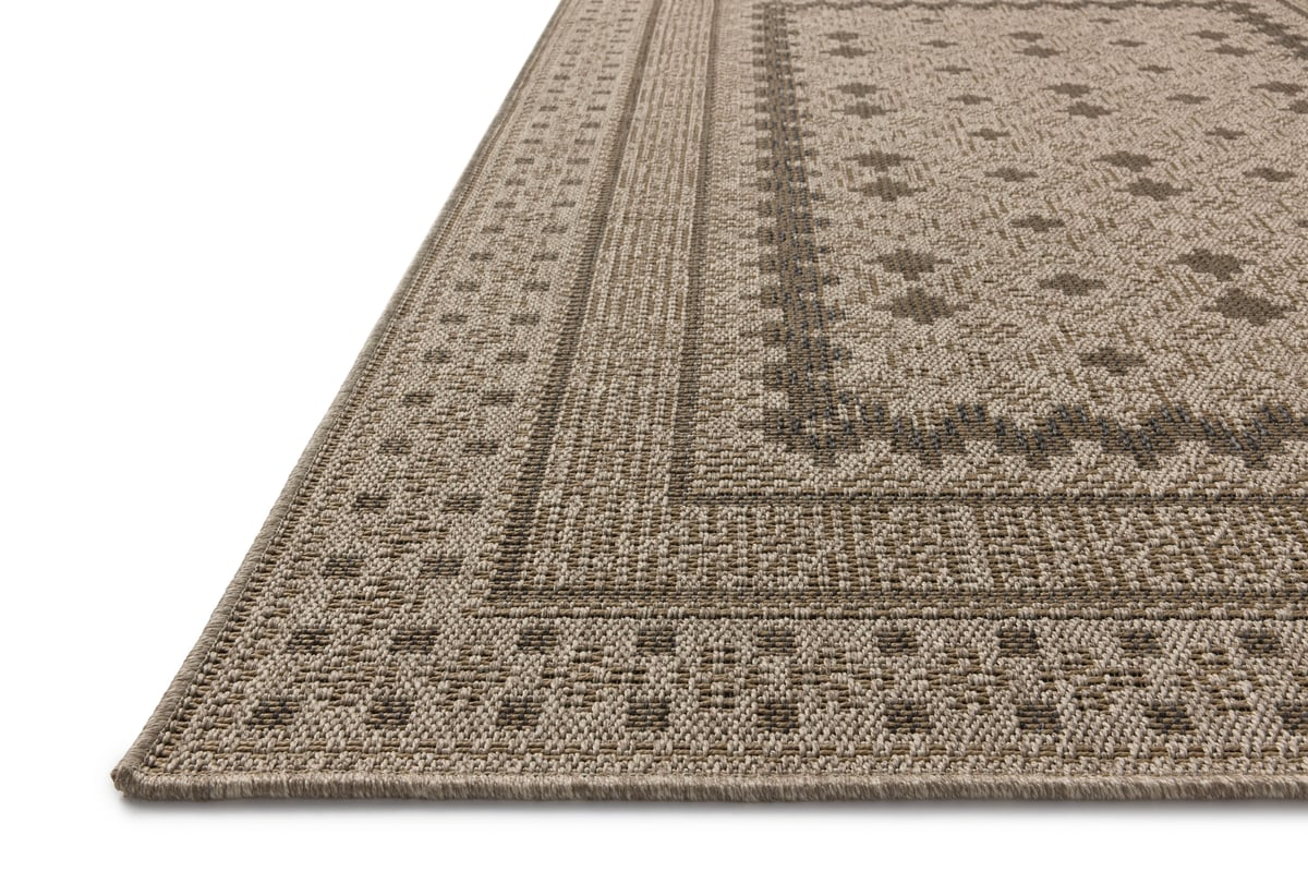 Beige geometric patterned rug with layered borders and textured woven appearance