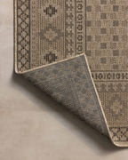 Beige geometric patterned rug with diamond motifs and decorative borders