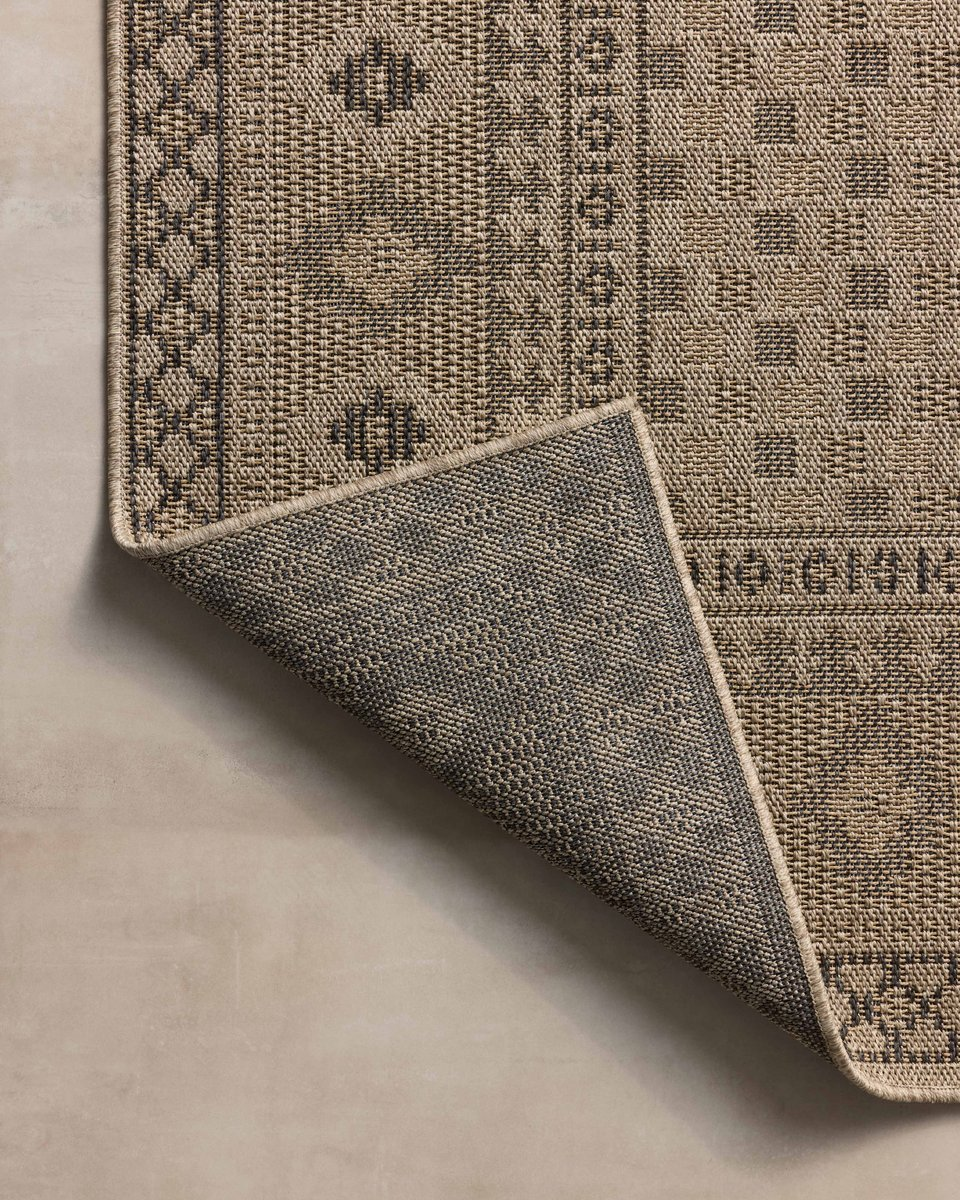 Beige geometric patterned rug with diamond motifs and decorative borders