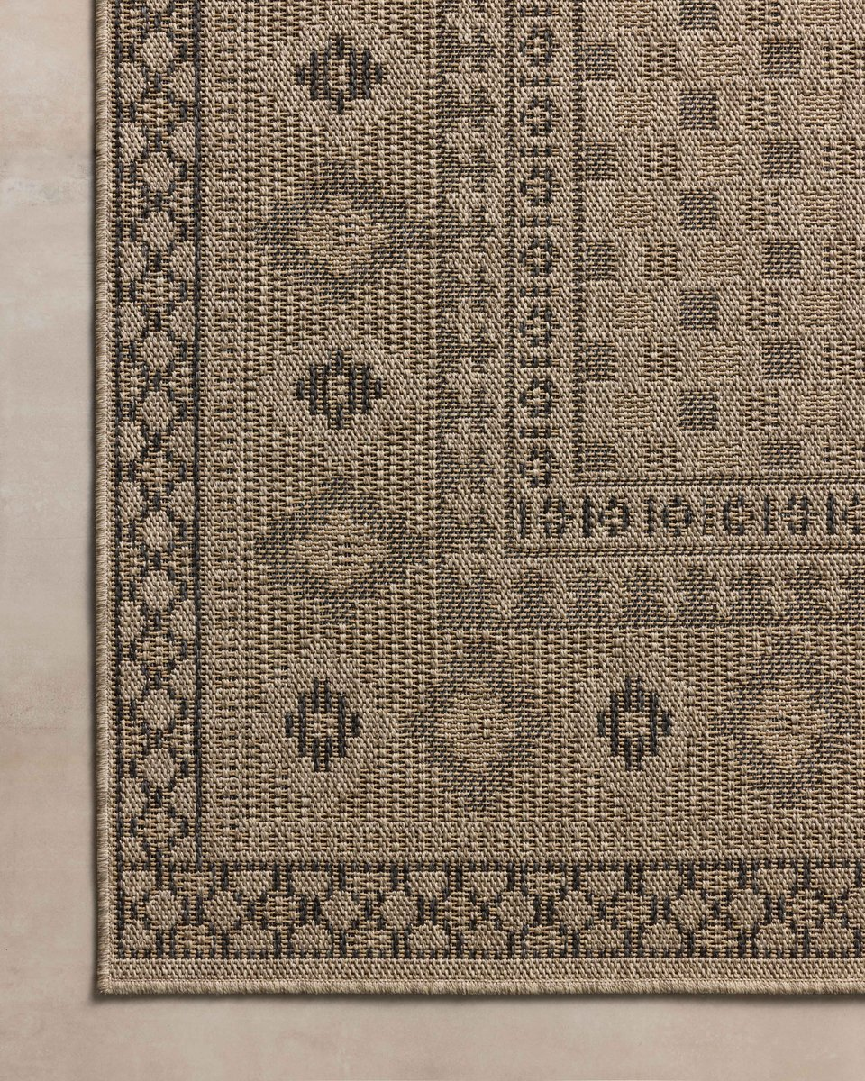 Beige geometric patterned rug with diamond motifs and decorative borders