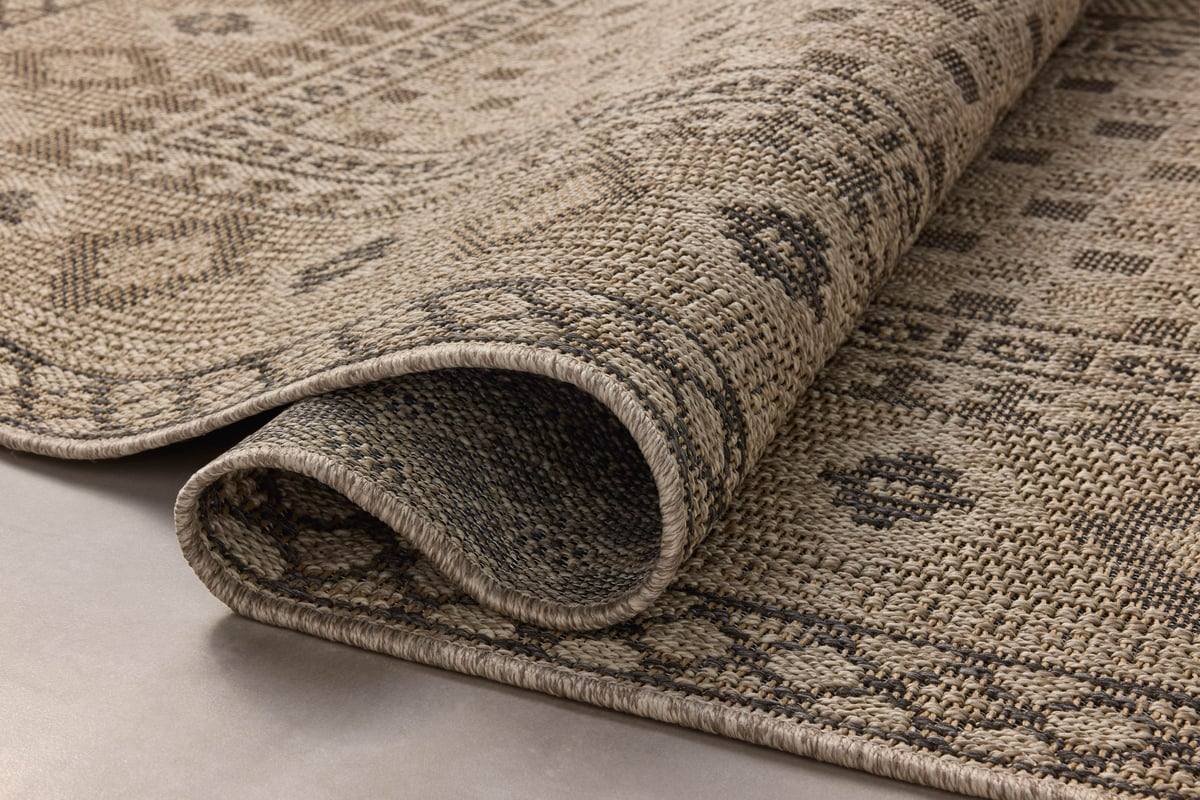 Beige geometric patterned rug with diamond motifs and decorative borders