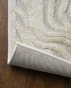 Cream wavy line patterned rug with organic swirled texture design