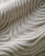 Cream wavy line patterned rug with organic swirled texture design