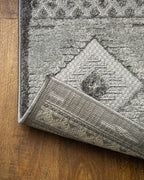 Gray geometric diamond pattern area rug with tribal motifs and striped borders