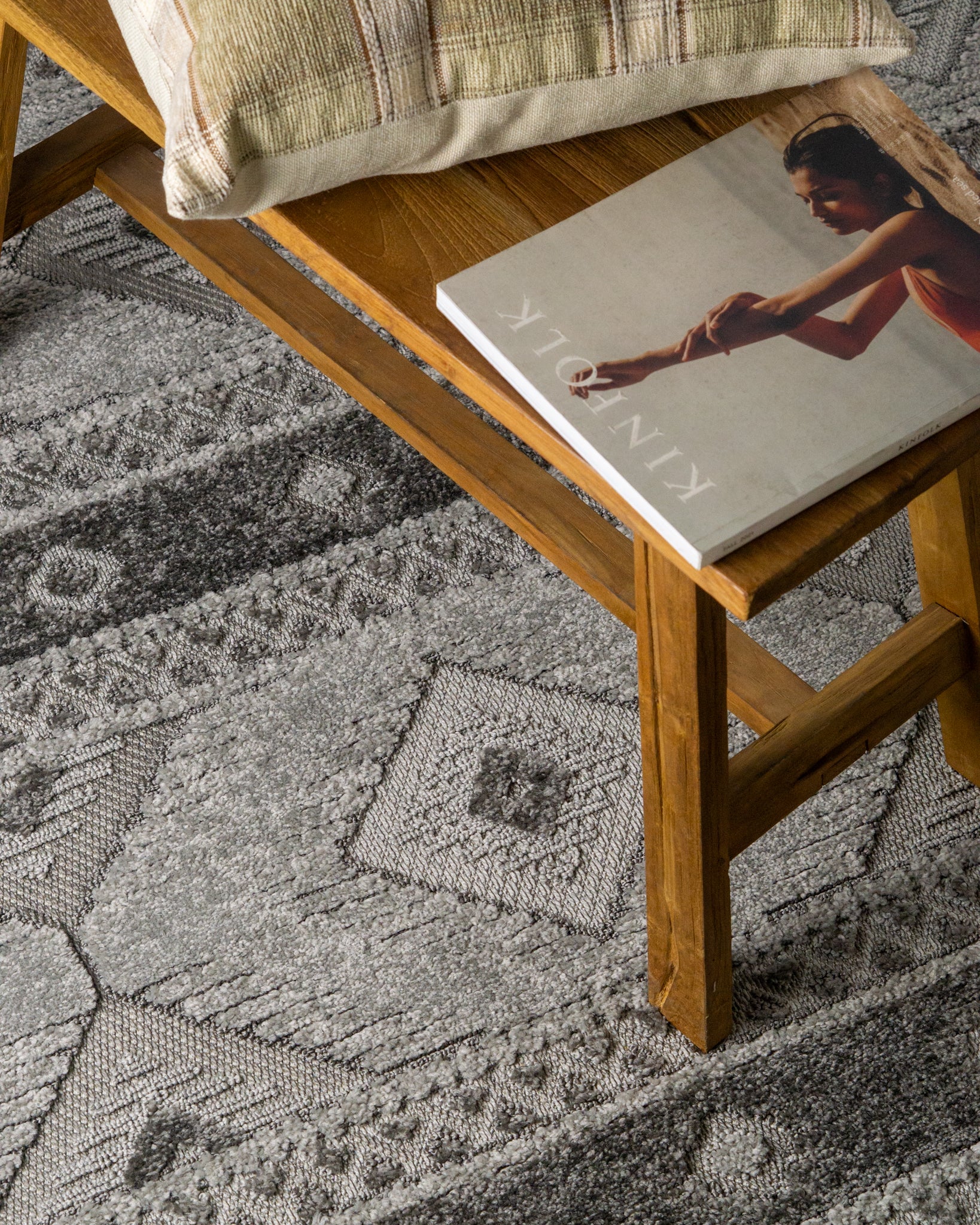 Gray geometric diamond pattern area rug with tribal motifs and striped borders
