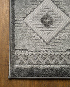 Gray geometric diamond pattern area rug with tribal motifs and striped borders