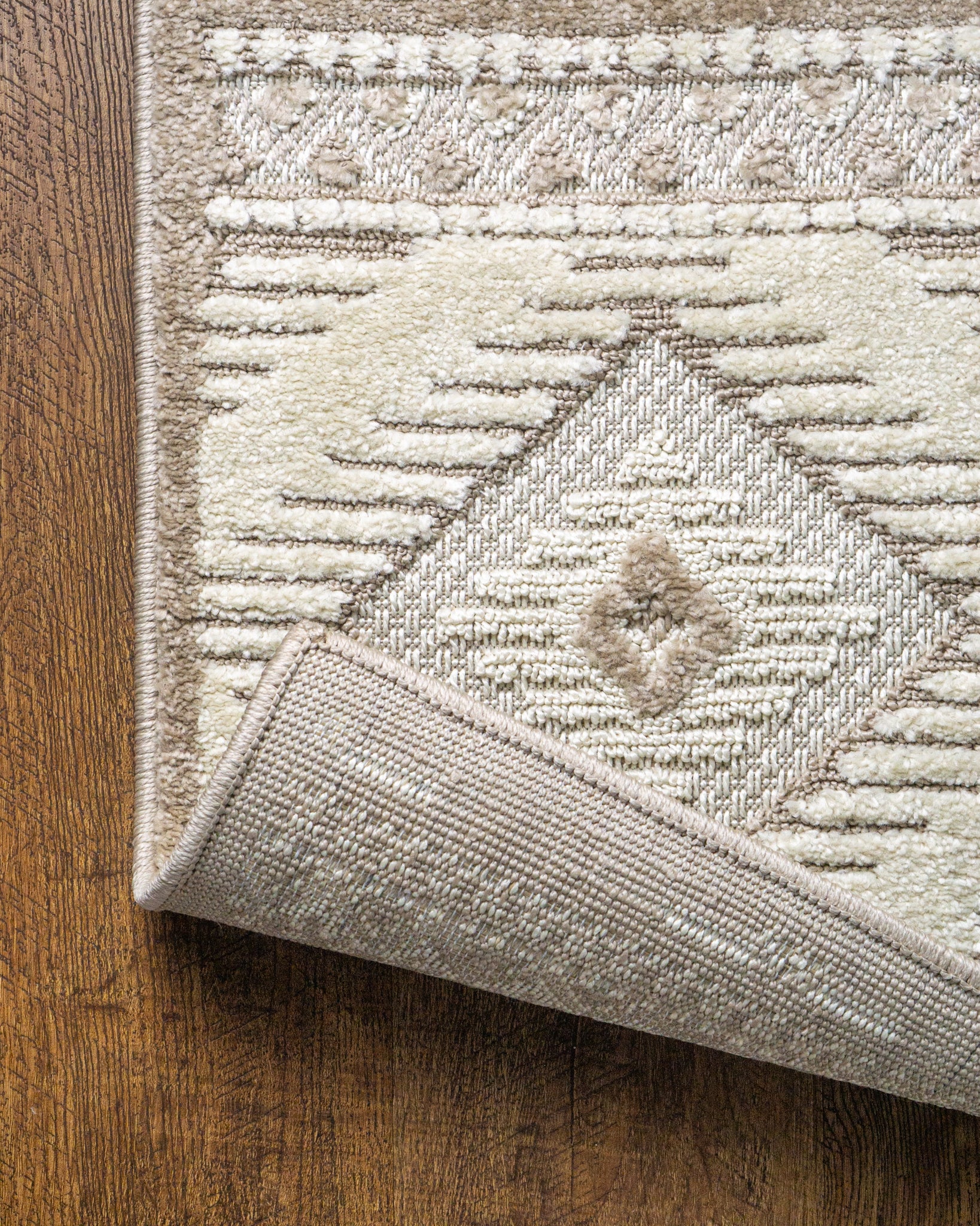 Beige and cream geometric diamond pattern rug with tribal inspired design