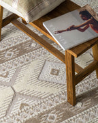 Beige and cream geometric diamond pattern rug with tribal inspired design