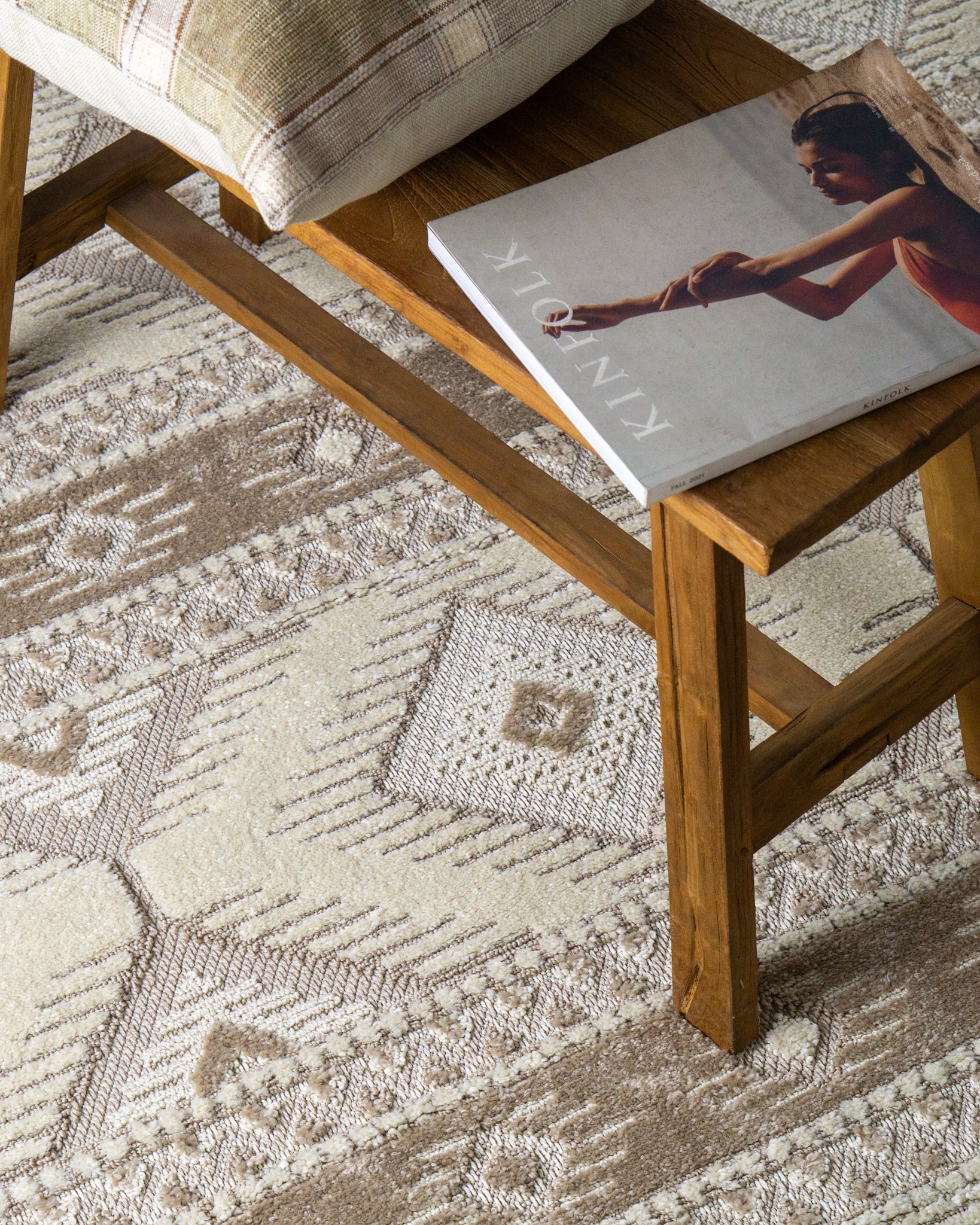 Beige and cream geometric diamond pattern rug with tribal inspired design