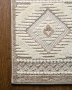 Beige and cream geometric diamond pattern rug with tribal inspired design