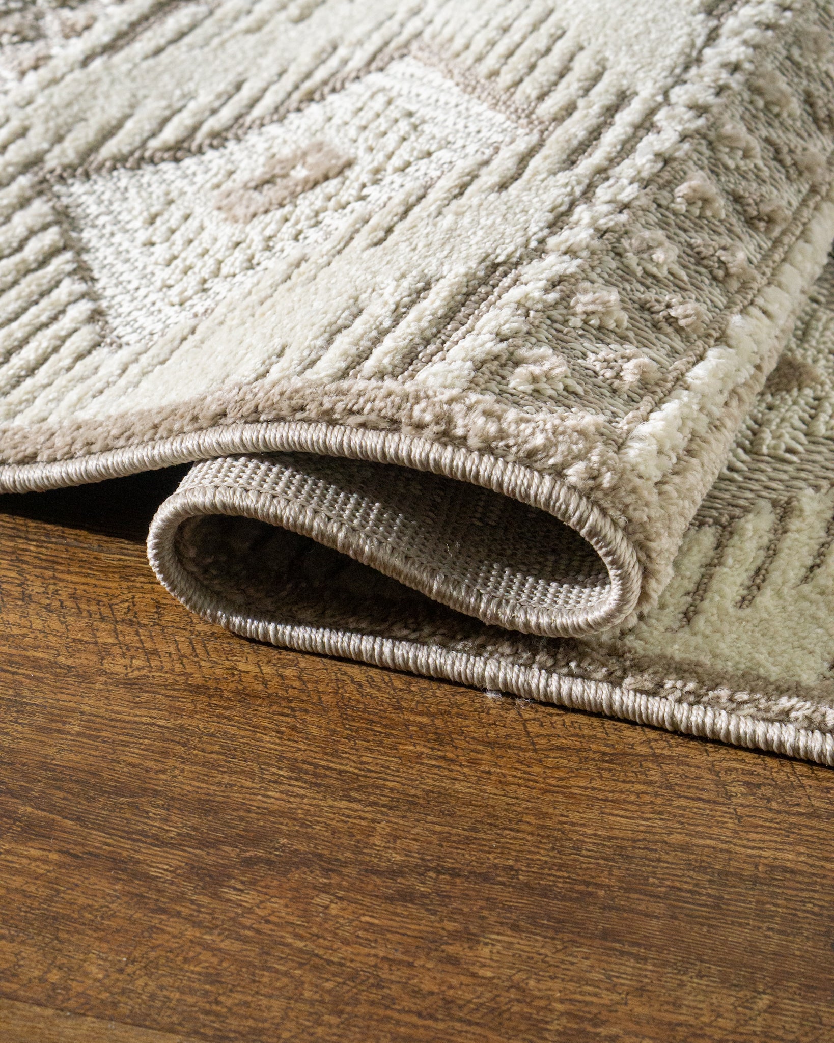 Beige and cream geometric diamond pattern rug with tribal inspired design