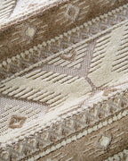 Beige and cream geometric diamond pattern rug with tribal inspired design