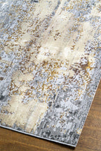 Abstract distressed rug with grey, gold, and cream tones in modern style