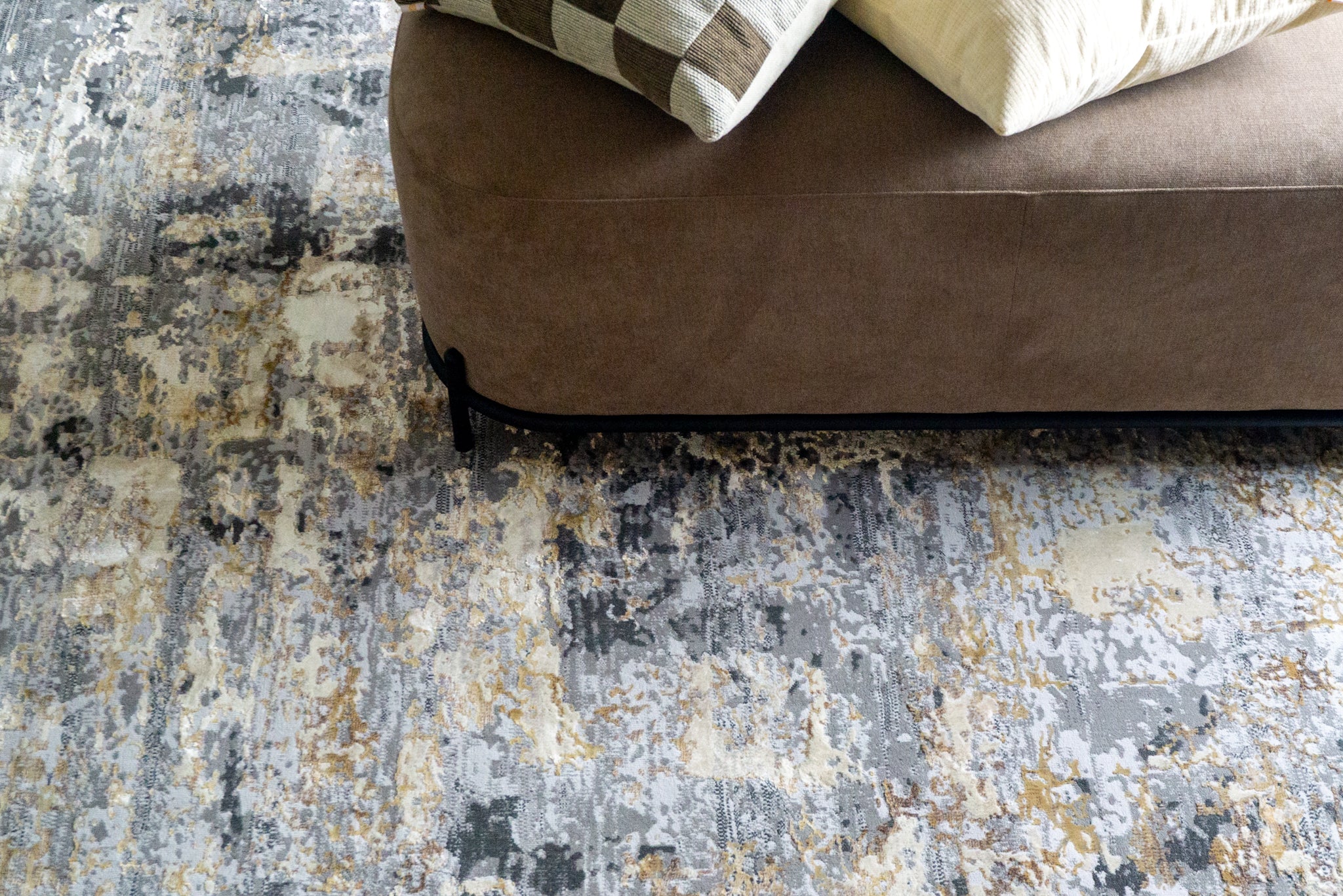 Abstract distressed rug with grey, gold, and cream tones in modern style