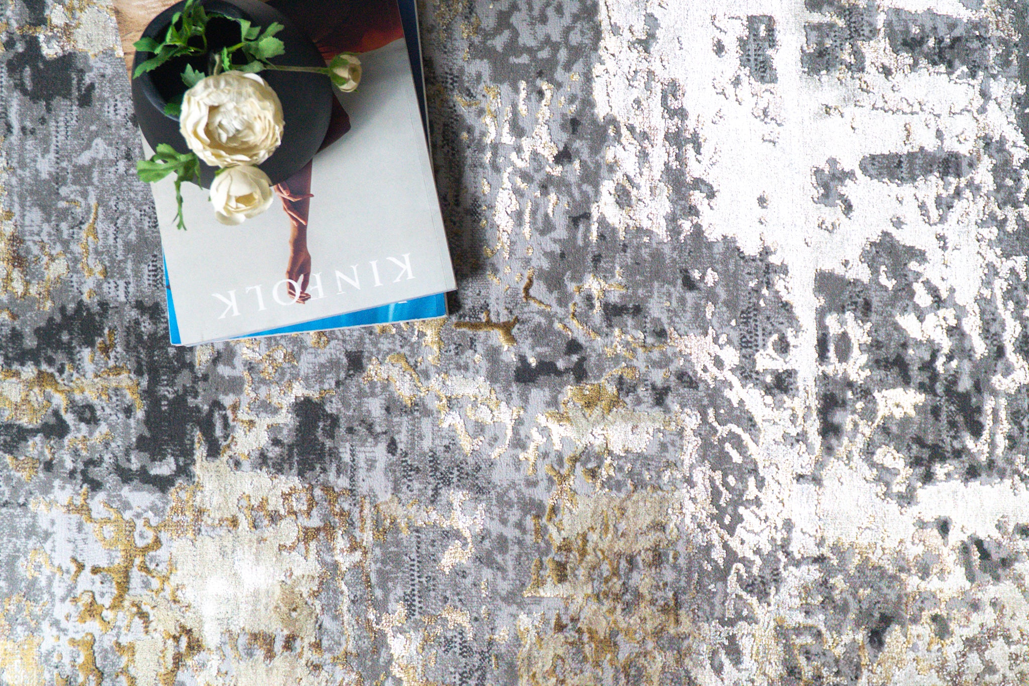 Abstract distressed rug with grey, gold, and cream tones in modern style