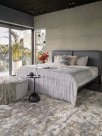Abstract distressed rug with grey, gold, and cream tones in modern style