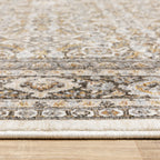 Traditional ornate rug with cream and brown geometric floral border pattern