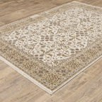 Cream and gold traditional rug with ornate floral patterns and decorative border