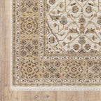 Cream and gold traditional rug with ornate floral patterns and decorative border