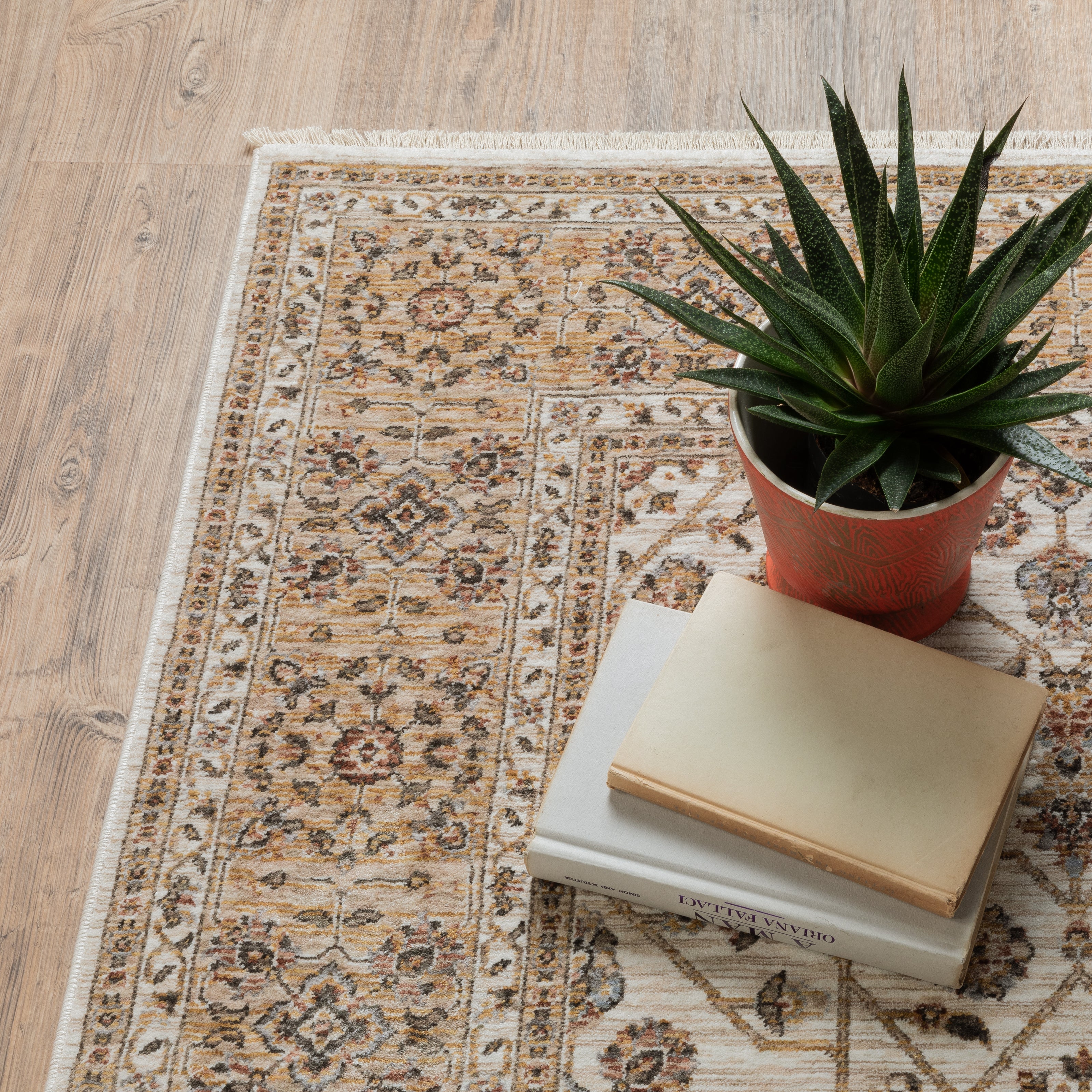 Cream and gold traditional rug with ornate floral patterns and decorative border