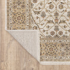 Cream and gold traditional rug with ornate floral patterns and decorative border
