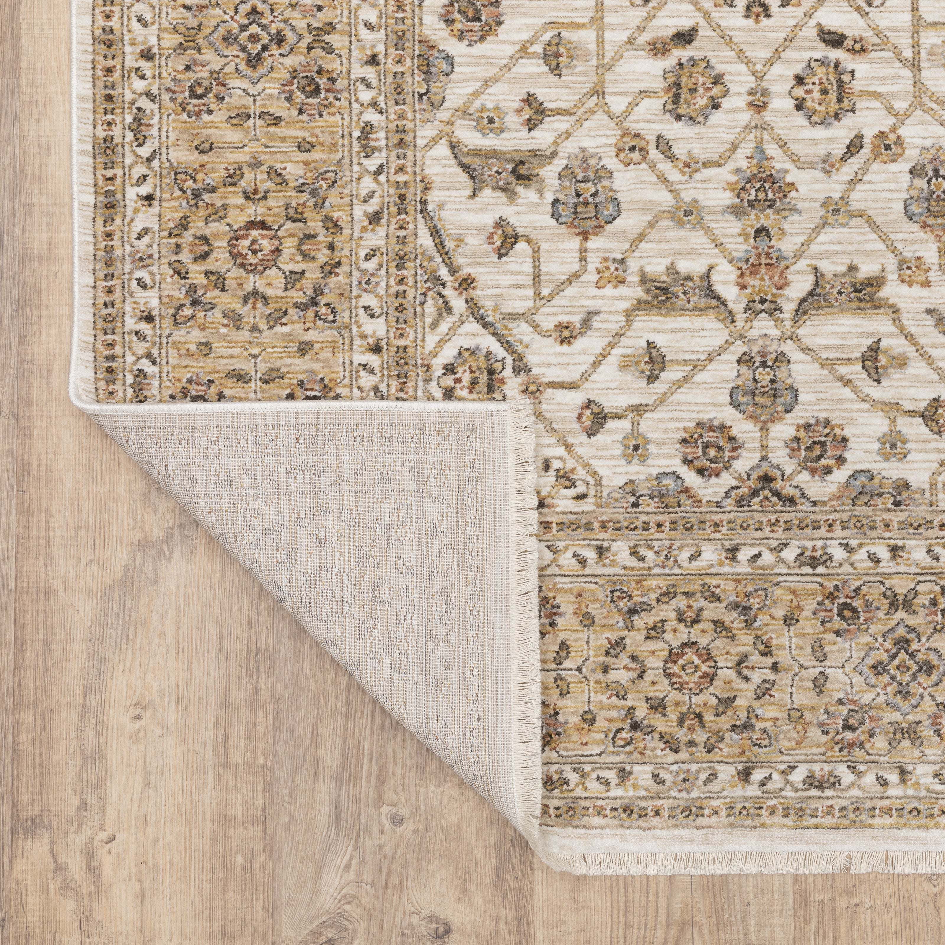 Cream and gold traditional rug with ornate floral patterns and decorative border