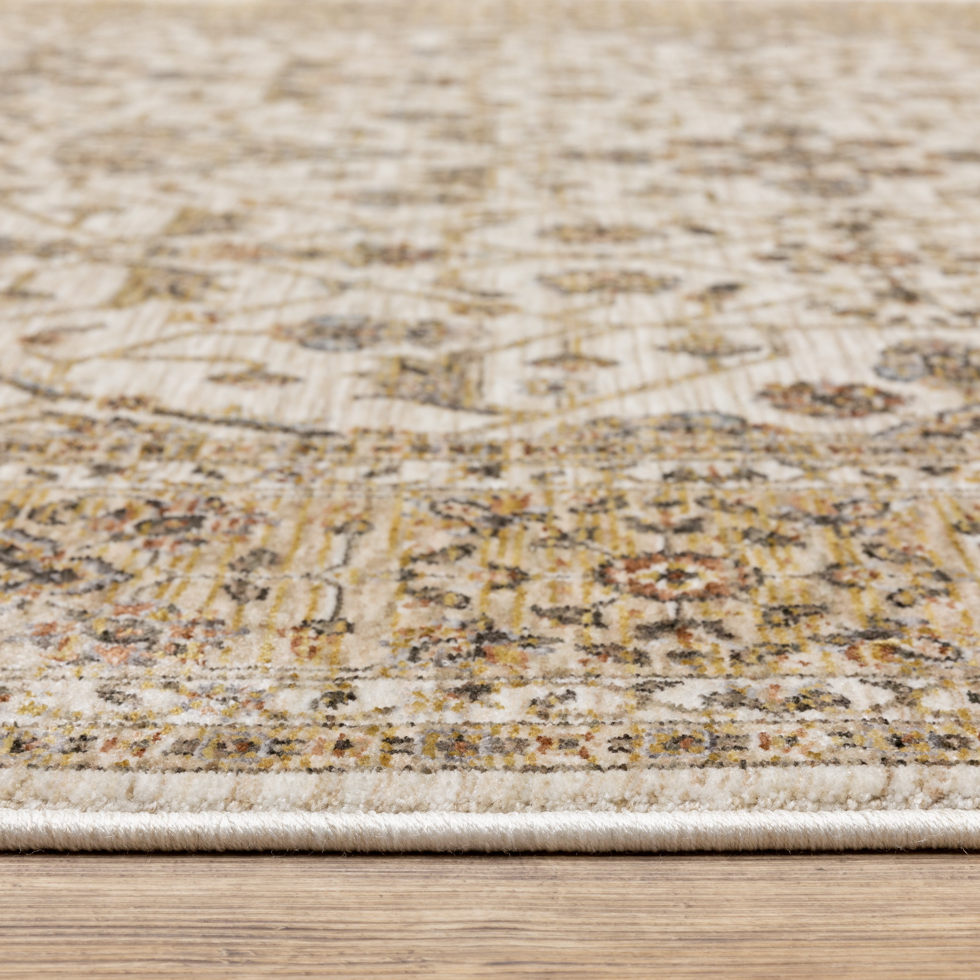 Cream and gold traditional rug with ornate floral patterns and decorative border