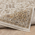 Cream and gold traditional rug with ornate floral patterns and decorative border