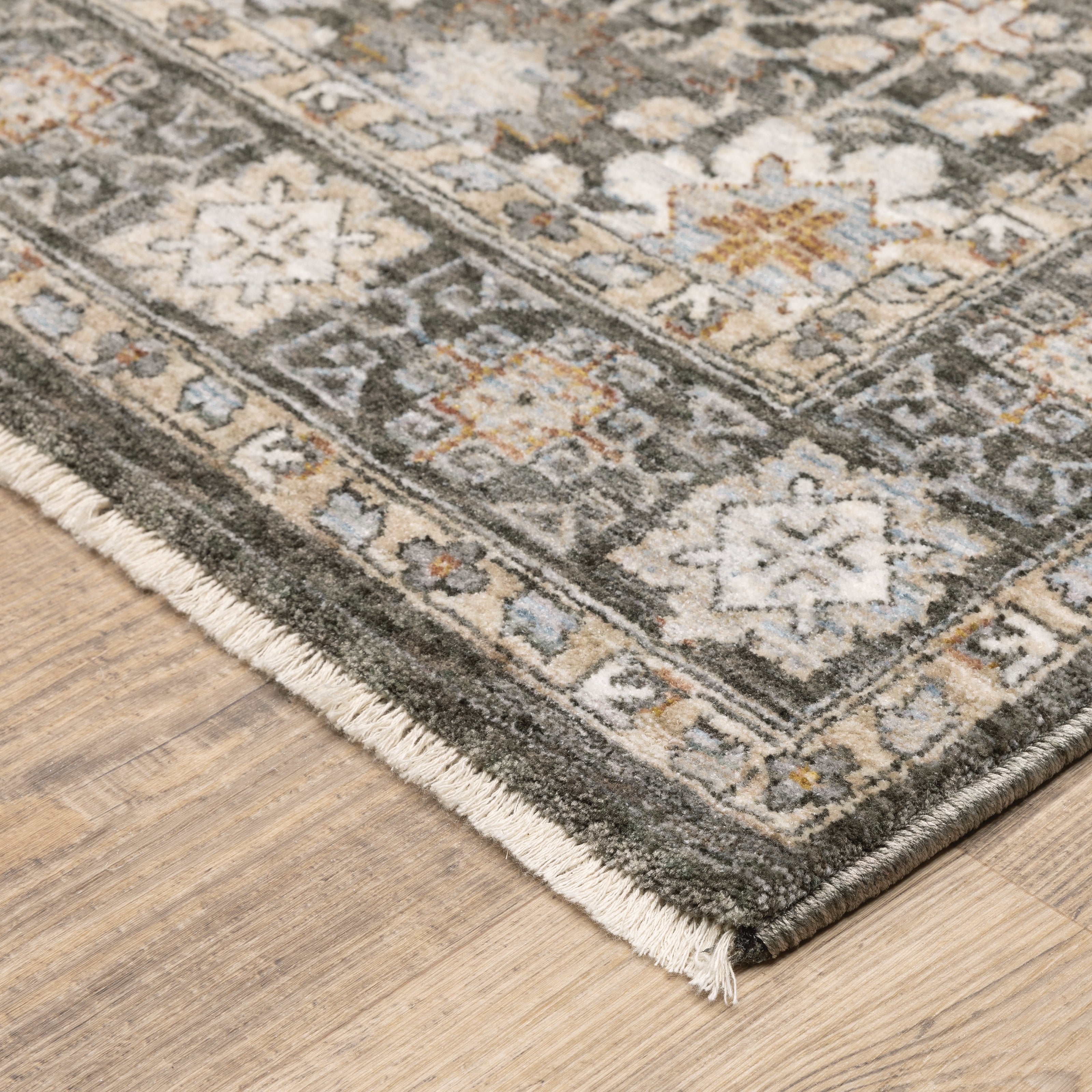 Vintage-style area rug with intricate geometric patterns in beige, taupe and cream tones