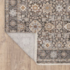 Vintage-style area rug with intricate geometric patterns in beige, taupe and cream tones