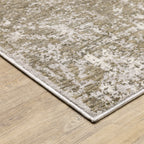 Distressed beige and tan vintage-style area rug with faded ornamental pattern