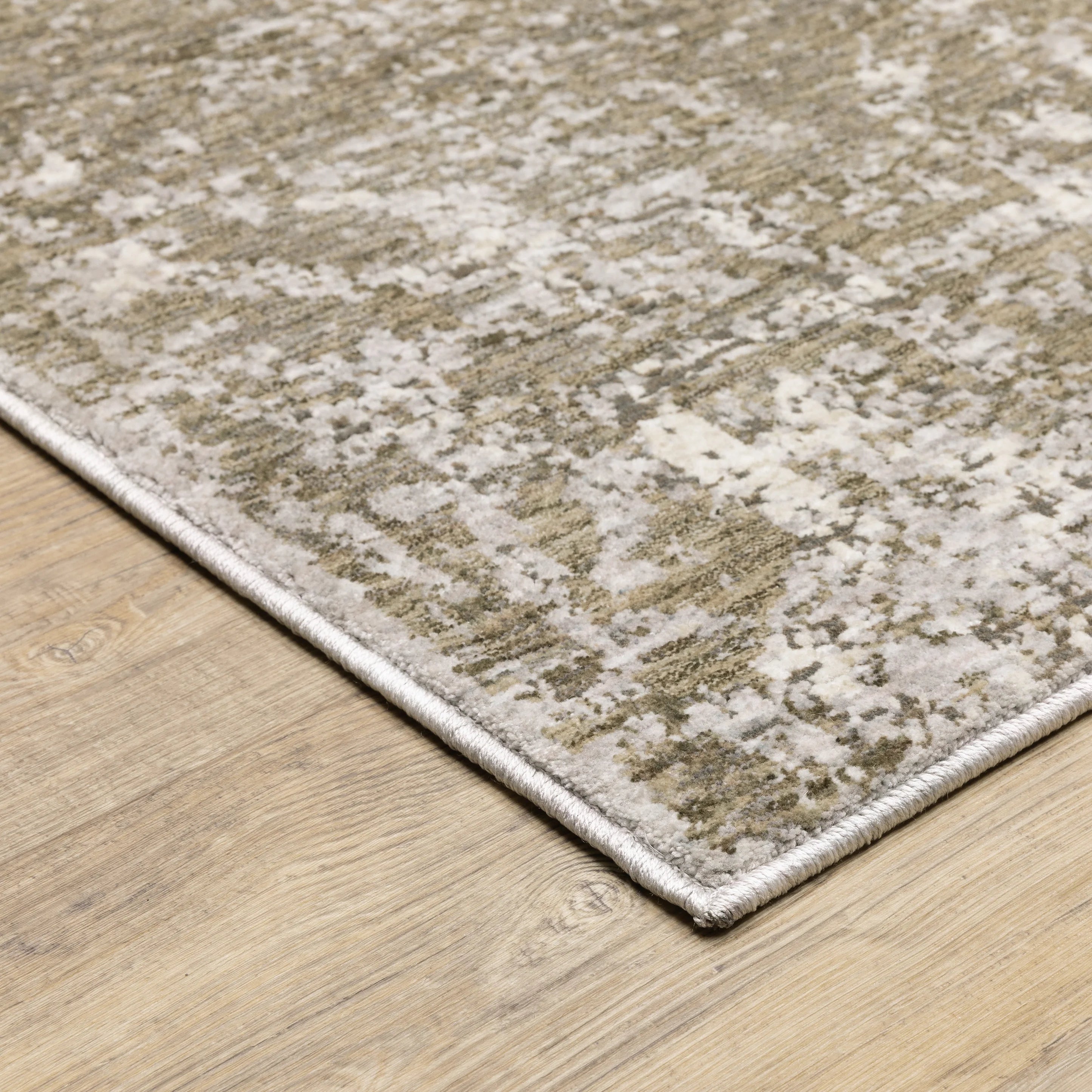 Distressed beige and tan vintage-style area rug with faded ornamental pattern