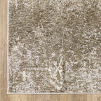 Distressed beige and tan vintage-style area rug with faded ornamental pattern