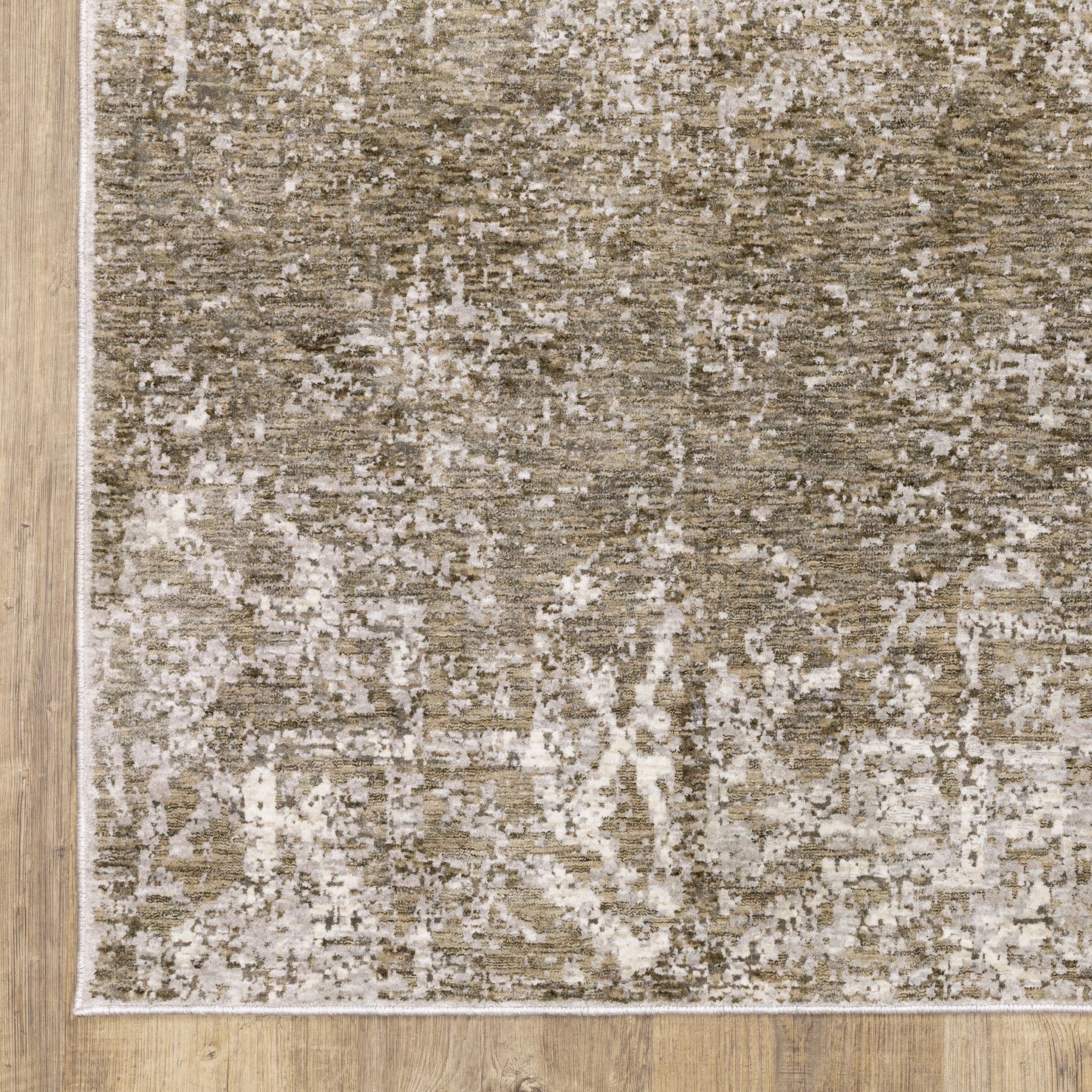 Distressed beige and tan vintage-style area rug with faded ornamental pattern