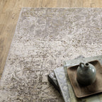 Distressed beige and tan vintage-style area rug with faded ornamental pattern