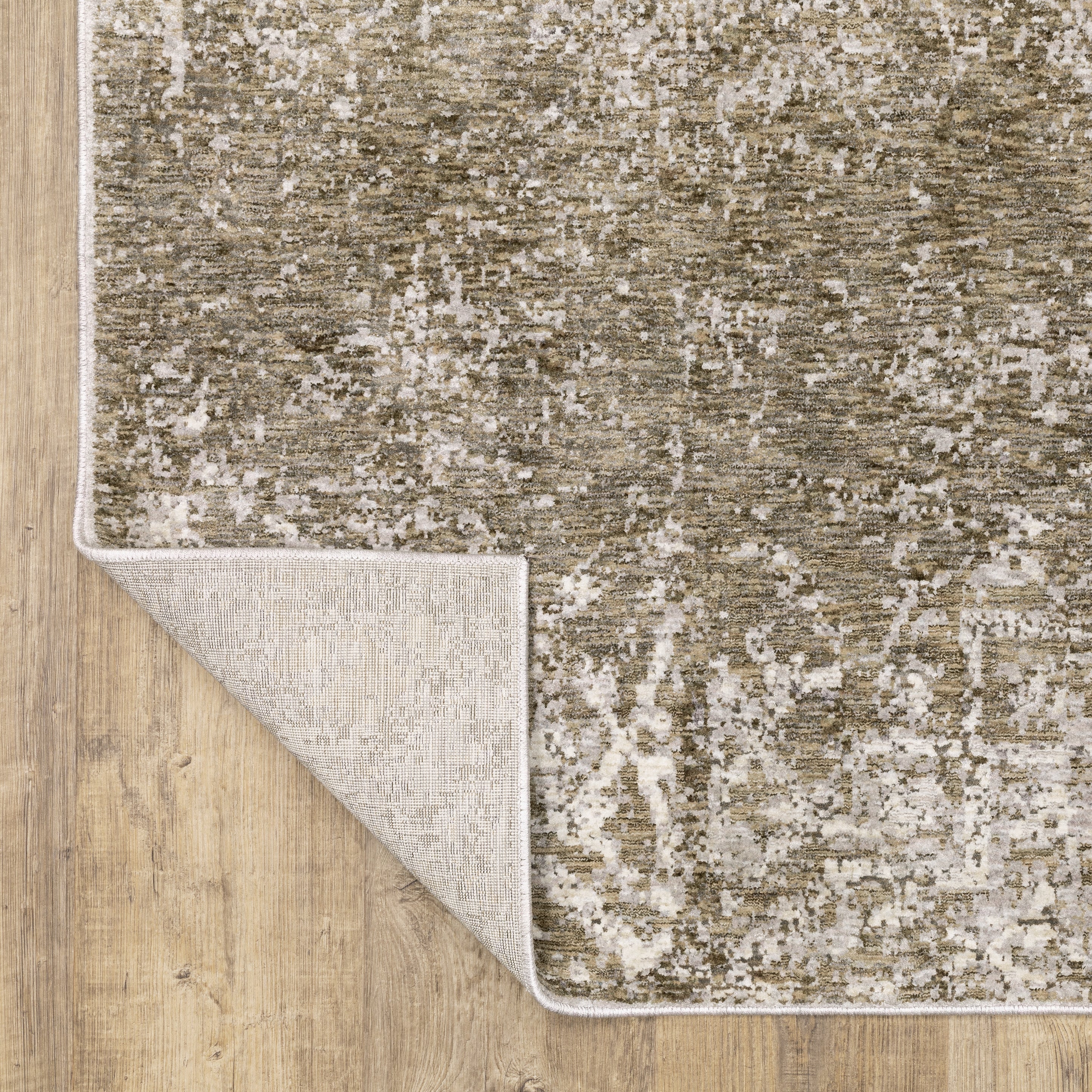 Distressed beige and tan vintage-style area rug with faded ornamental pattern