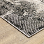 Vintage distressed grey and cream rug with abstract mottled texture pattern