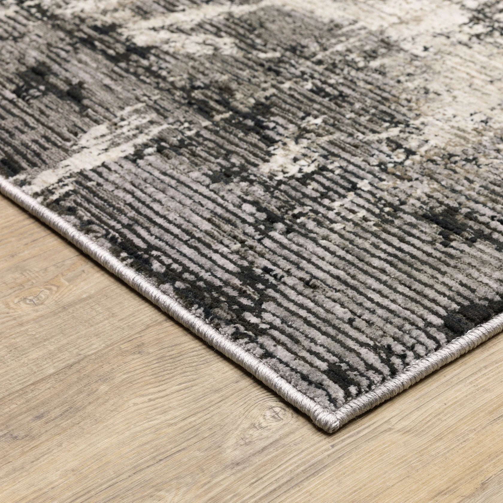 Vintage distressed grey and cream rug with abstract mottled texture pattern