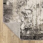 Vintage distressed grey and cream rug with abstract mottled texture pattern